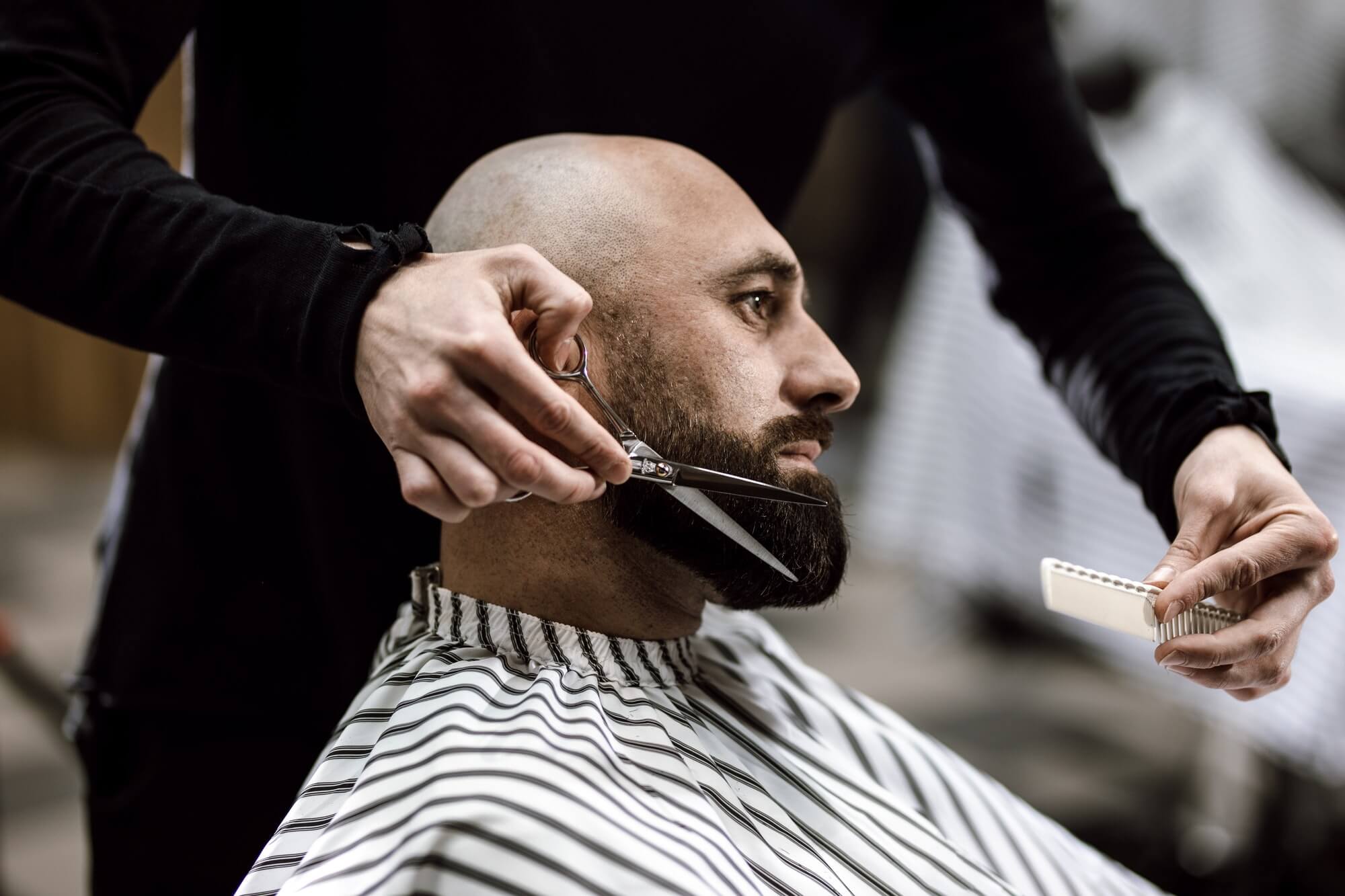 fashion-barber-dressed-in-a-black-clothes-scissors-beard-of-brutal-man-in-the-stylish-barbershop.jpg