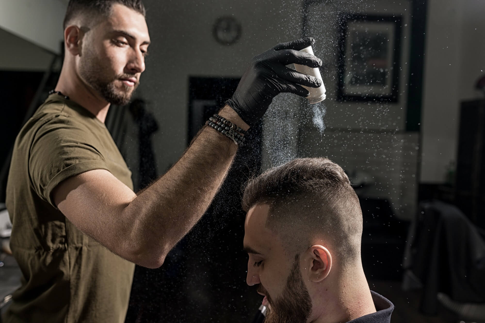 handsome-barber-is-fixing-the-styling-of-brutal-young-man-with-a-dry-styler-at-a-barbershop.jpg